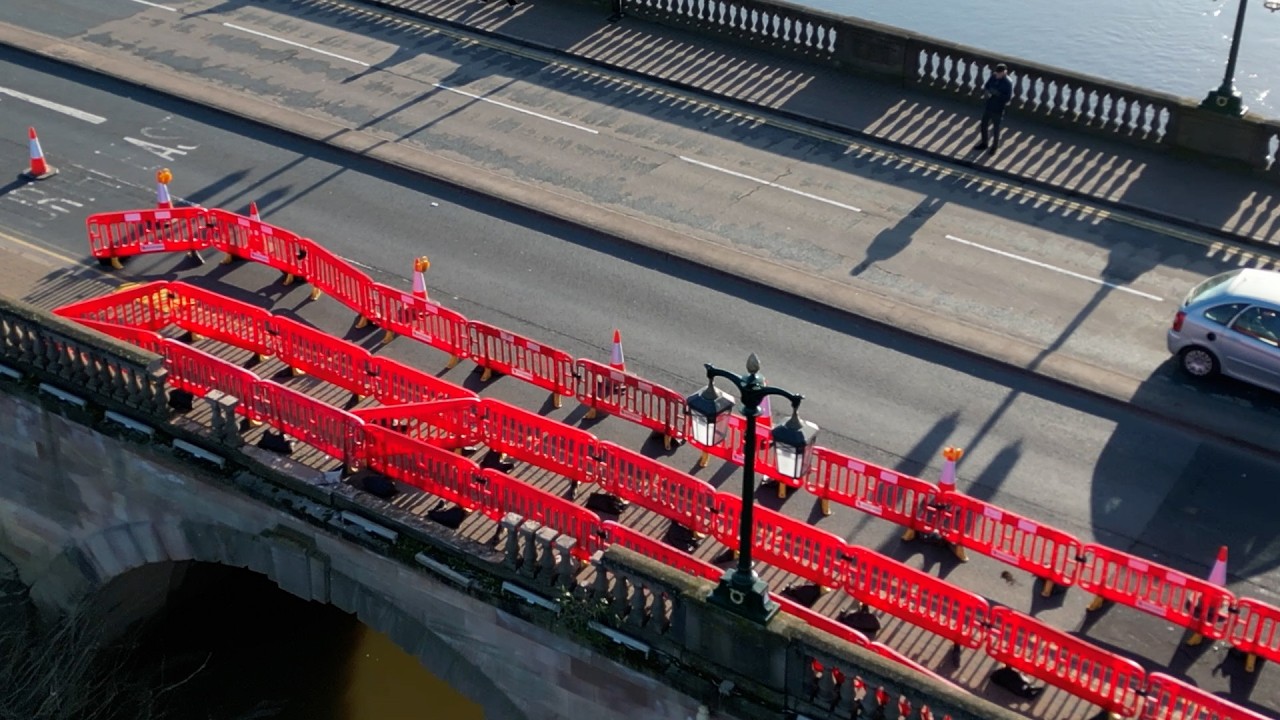 Damage after Police car left dangling over edge of bridge during emergency | SWNS