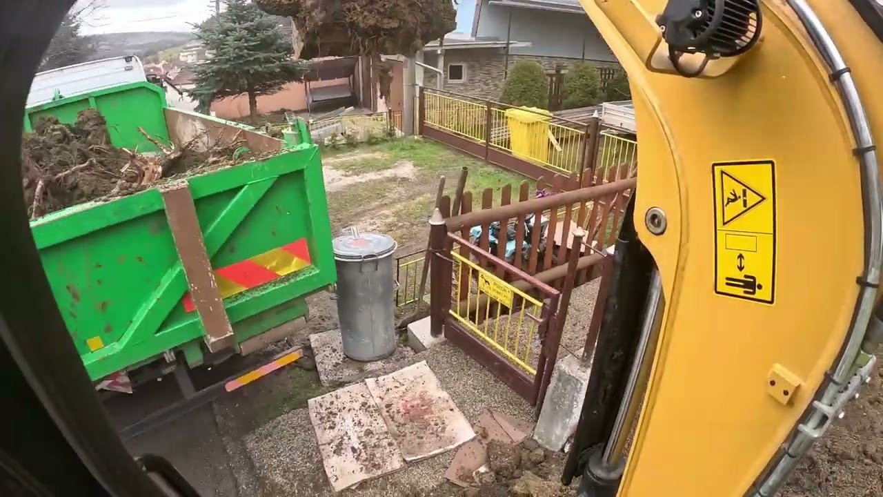 Odkop zo záhrady. Cat 302.7 excavator loading dump truck. CAB VIEW