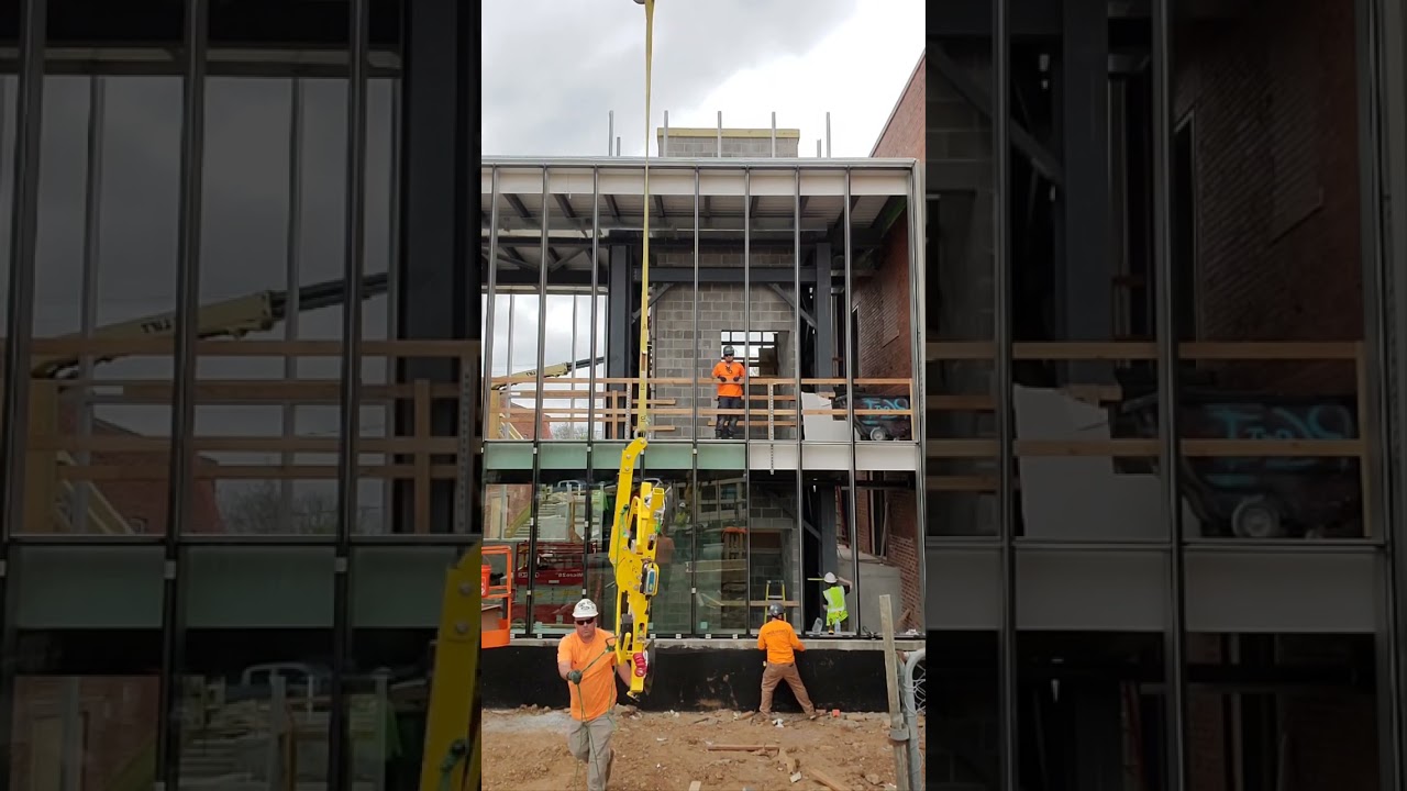 using a crane and power cup to set glass panels at KCPBS.