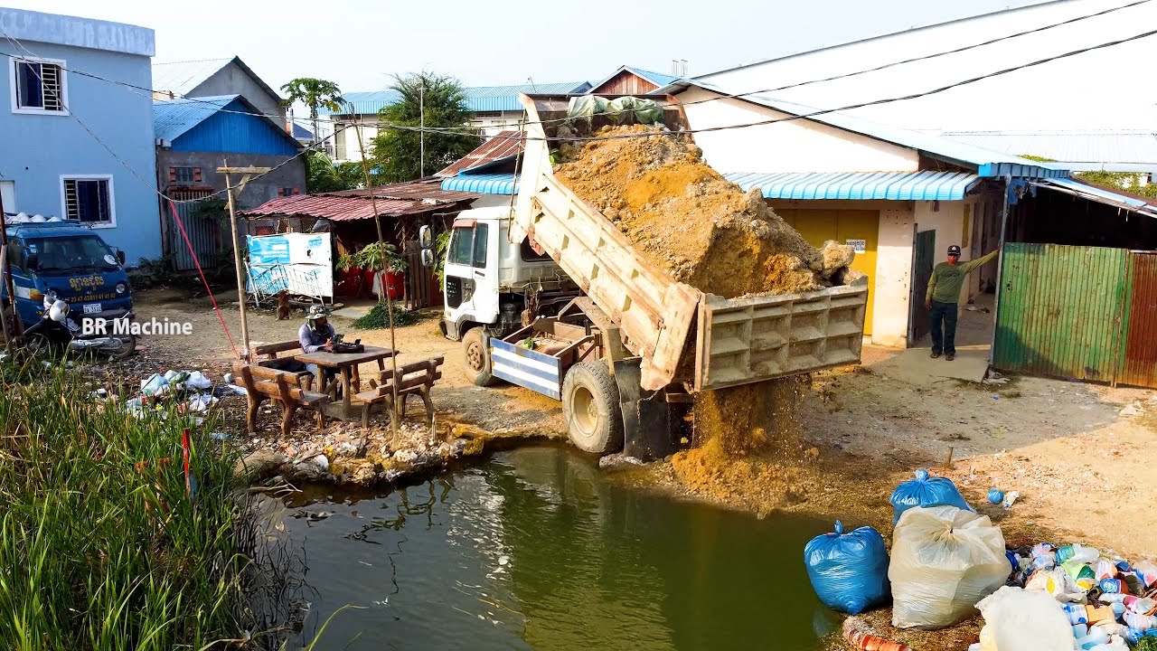 Excellent project with dump truck and bulldozer filling the flood land complete 100 %