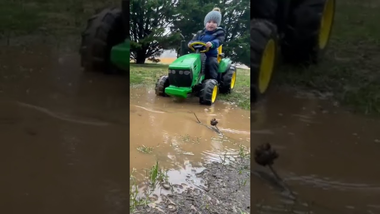 YOURE GONNA SINK!😵😵 Kid riding john deer tractor in the mud rain muddy puddle splashes