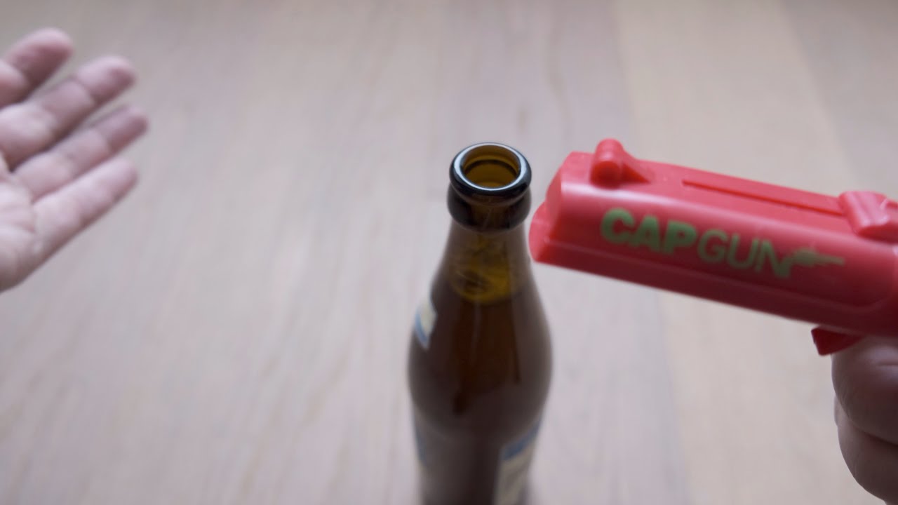 Cap gun bottle opener