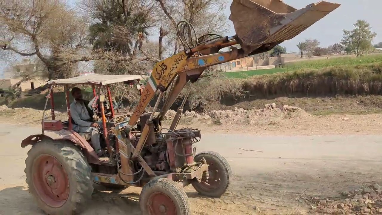The loader 🚜 tractor is collecting the bricks scrap 