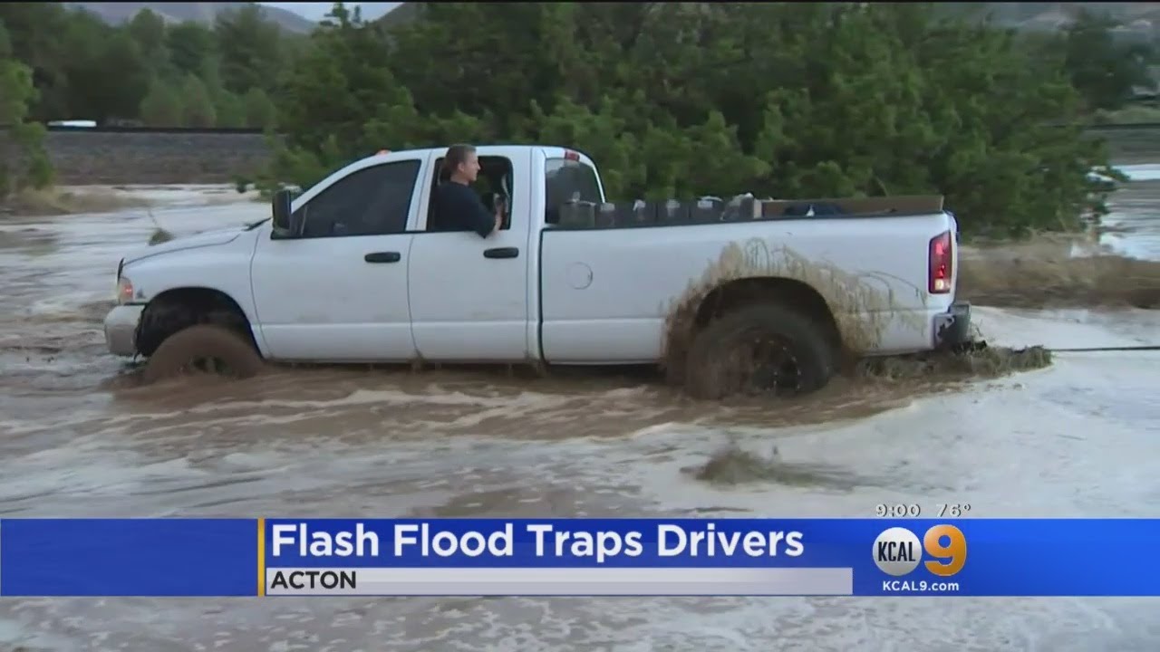 Rain Floods Streets Of Acton, Traps Drivers