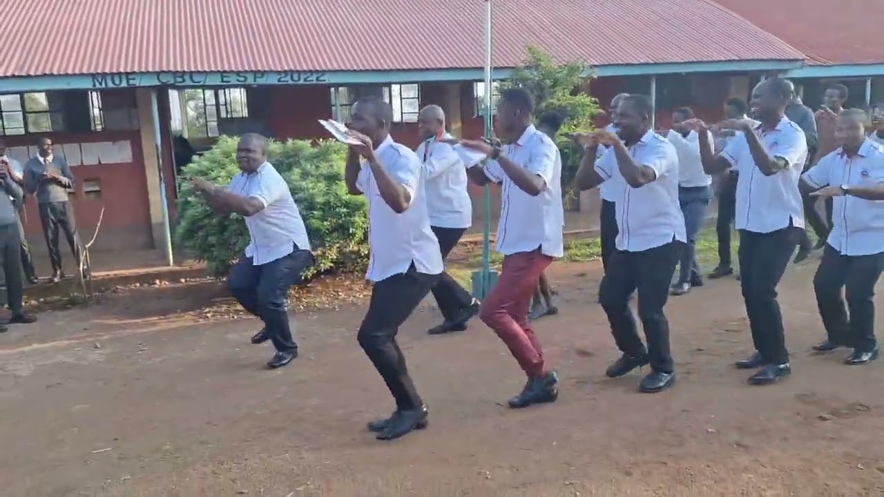 ST. INNOCENT JONYO STAFF PERFORMING AT THE ASSEMBLY