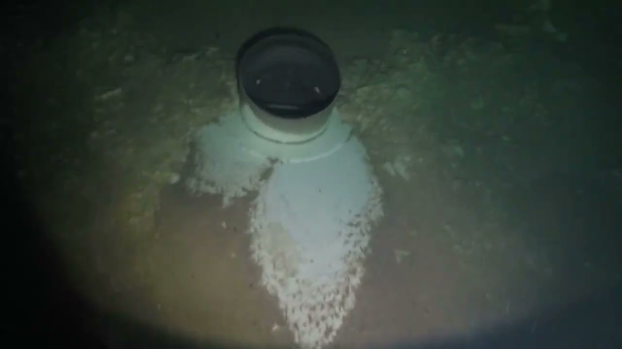 Diver inside water tower in TX with deep sediment