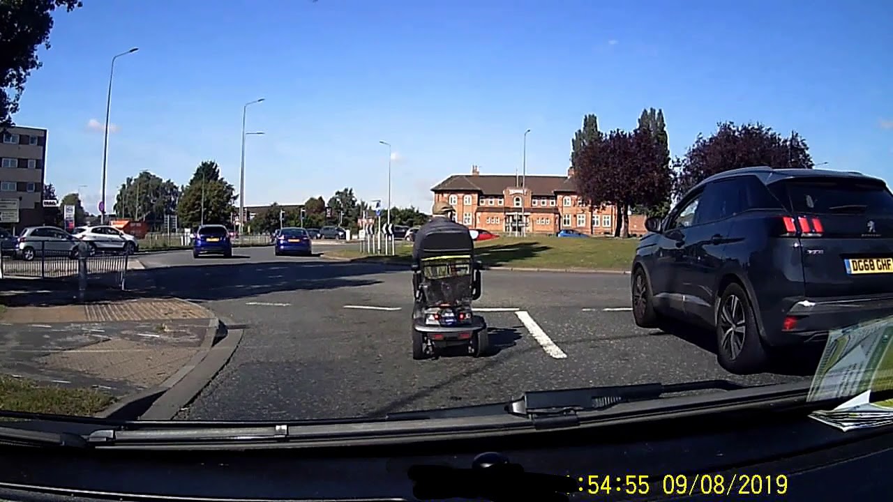 Scooter driving on a busy roundabout  08/09/19