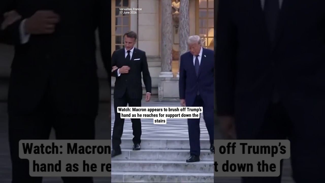 Watch: Macron appears to brush off Trump&rsquo;s hand as he reaches for support down the stairs