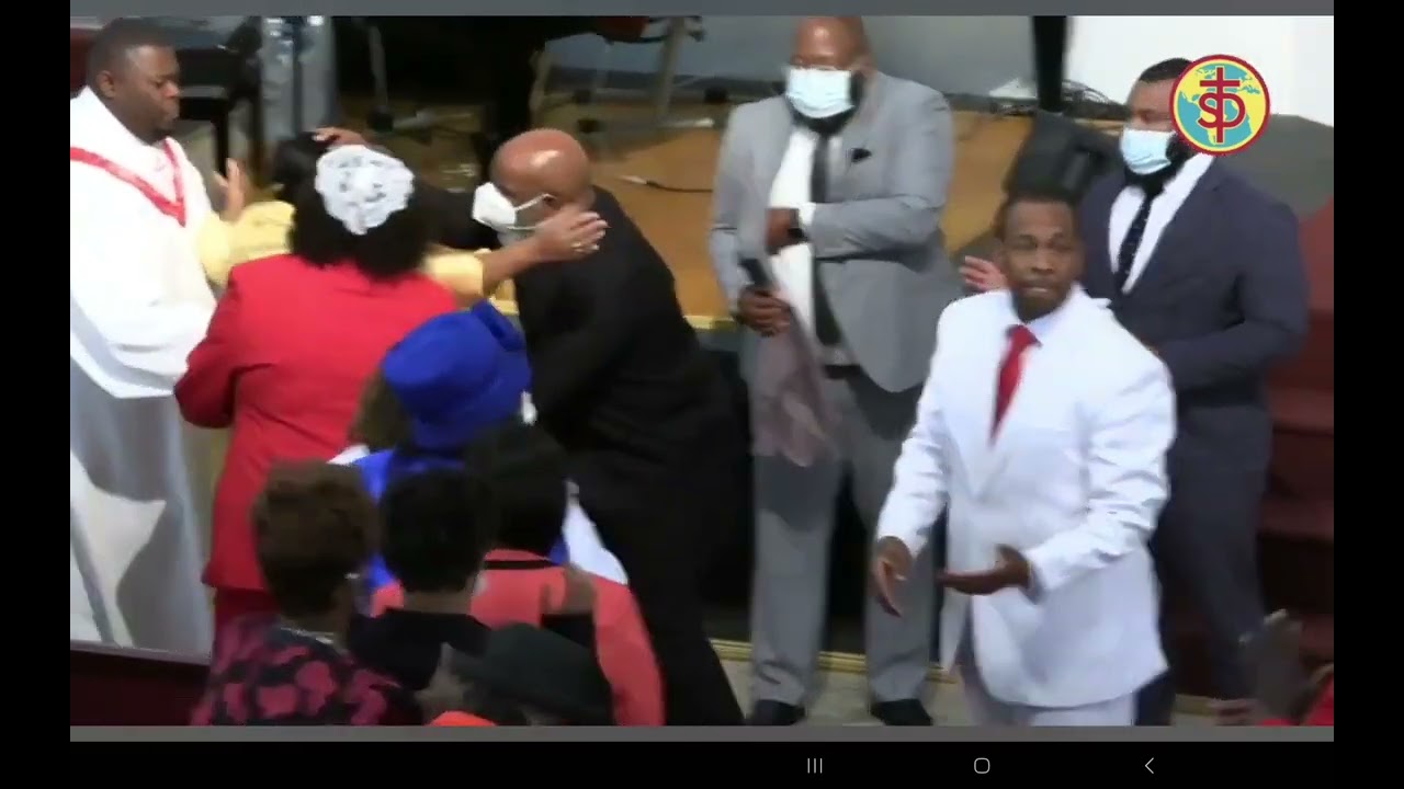 Apostle Joseph Hamilton laying hands on the saints at St John's deliverance temple in Mobile AL,