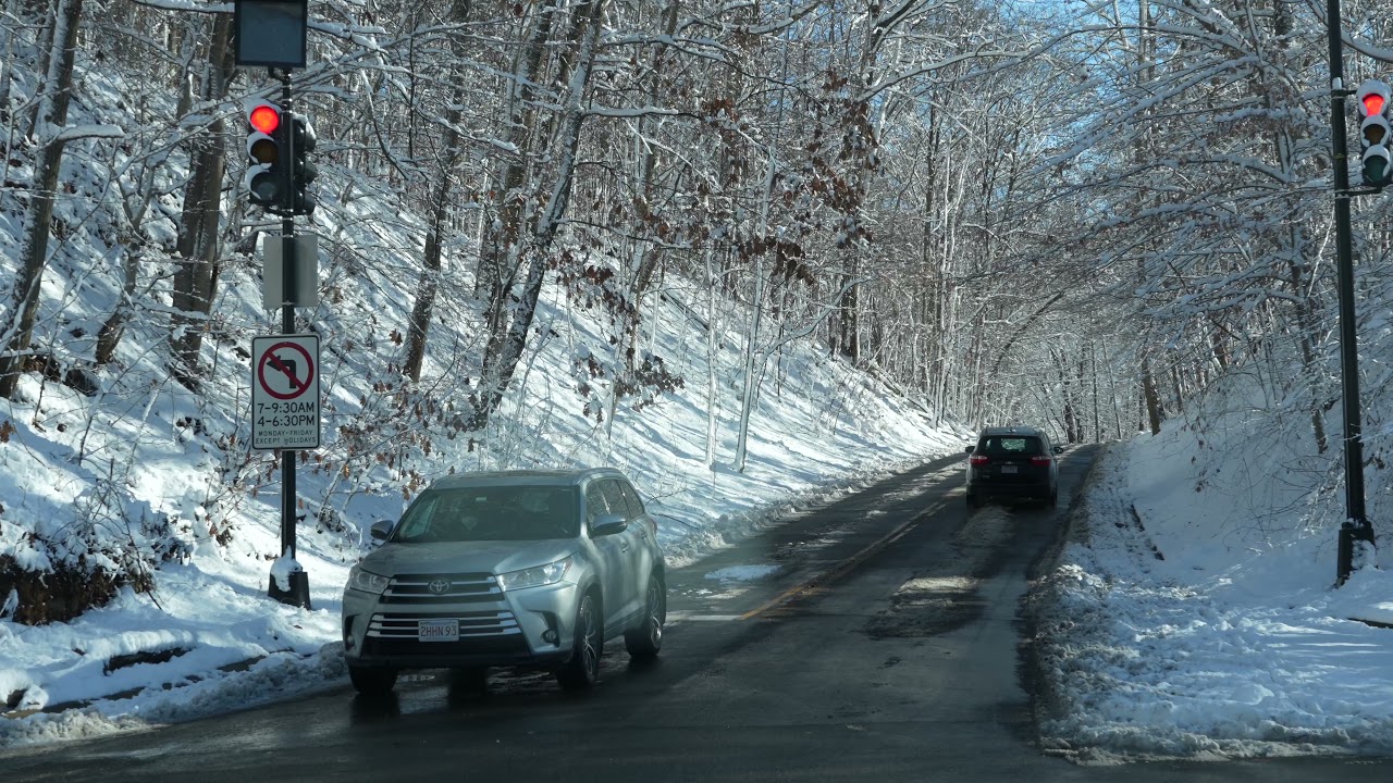 Drive through Washington, D.C.'s Rock Creek Parkway after the snow has fallen.