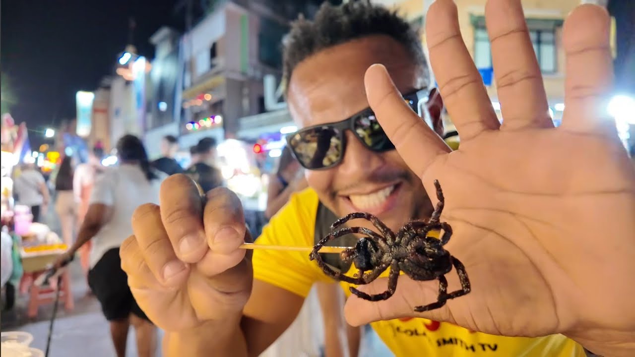 Jamaican youtuber tries deep fried venomus tarantula || Thailand bizarre street food 