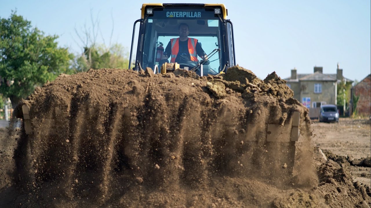 Cat 963K Track loader Leveling Piles of Dirt
