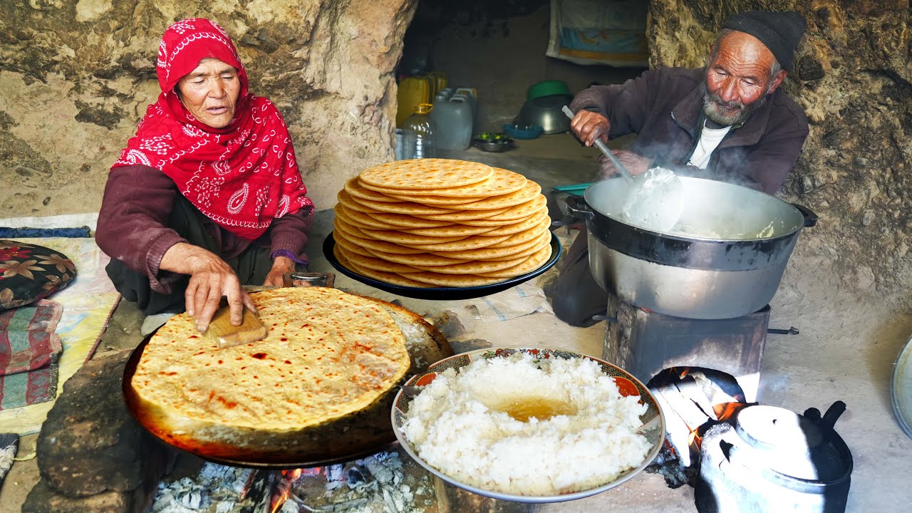 Old Couple Cooking Village Style Rice Pudding and Lavash Bread Inside a Mountain Cave