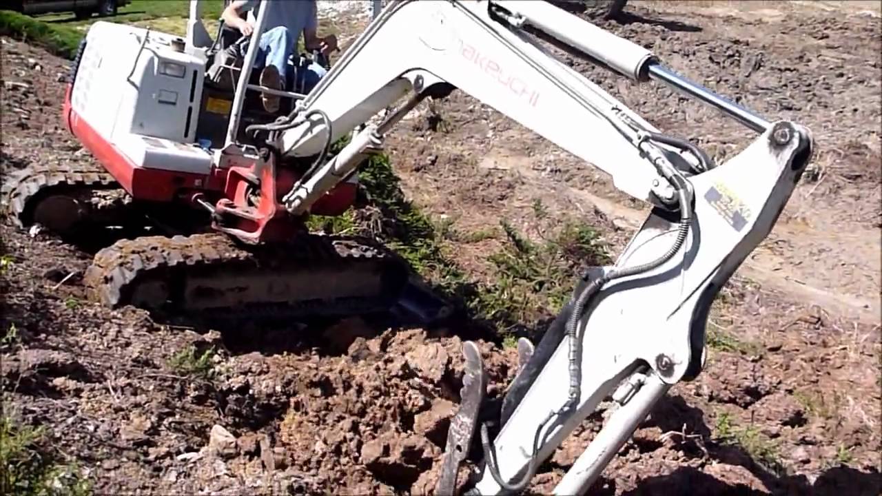 Mini Excavator Working a Steep Slope