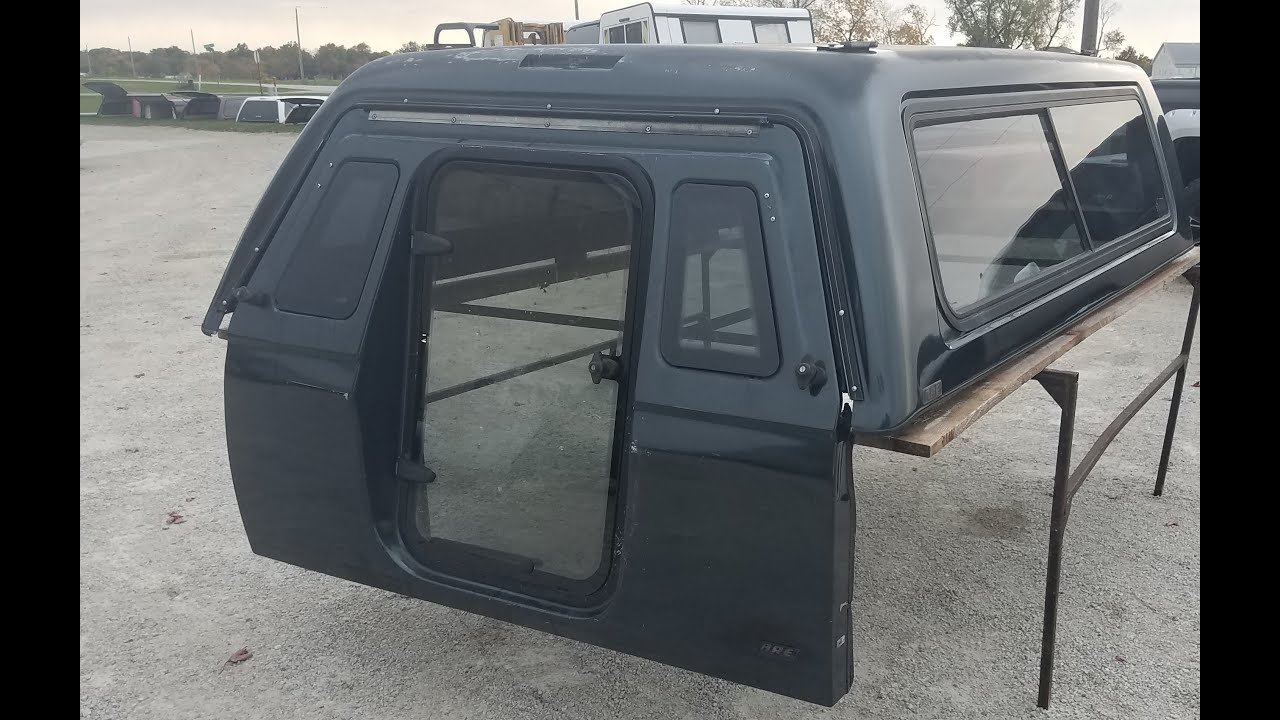 Walk around used fiberglass ARE MX series camper shell with walk-in door for sale. 99-16 Super Duty
