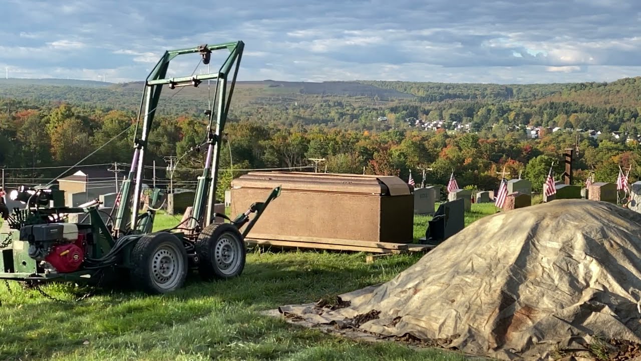 Installing Burial Vault for above ground Wilbert Way set up with vault buggy.