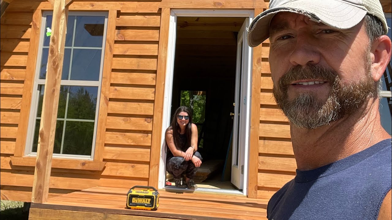 River A Frame: Lap siding installation, exterior stain coating, and porch construction.