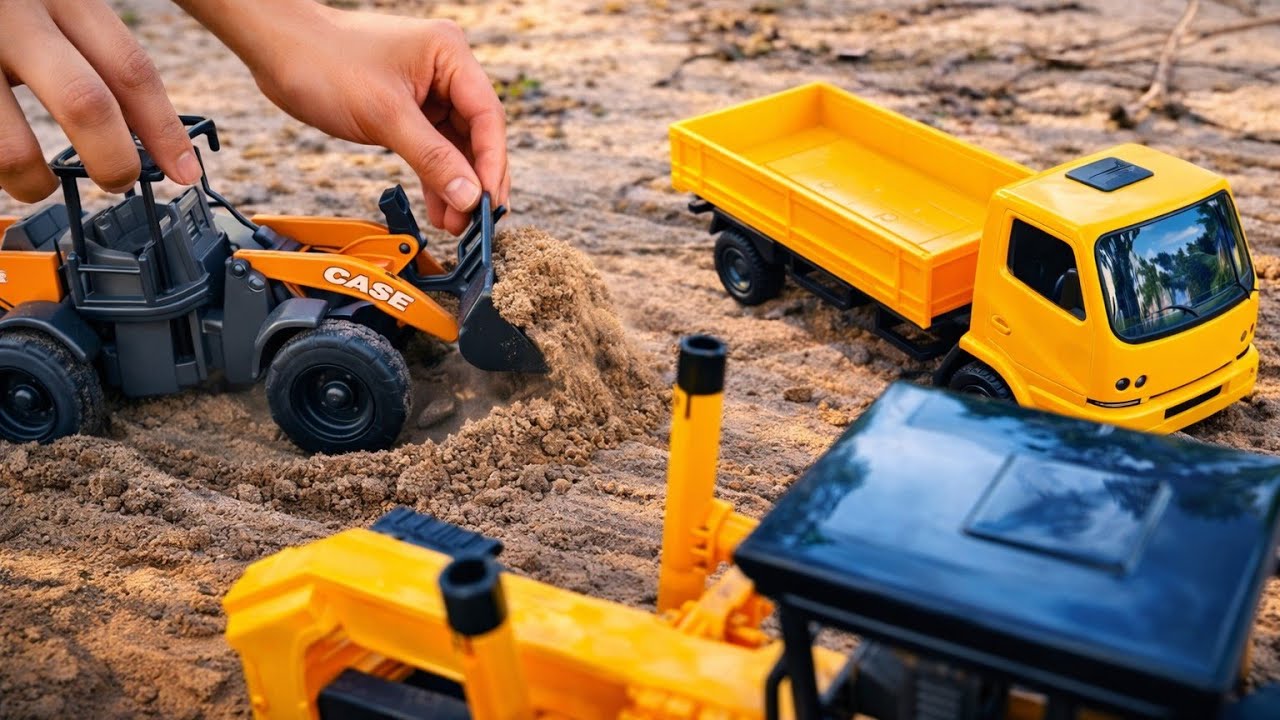 Brincadeira na areia com as máquinas e caminhões de brinquedo