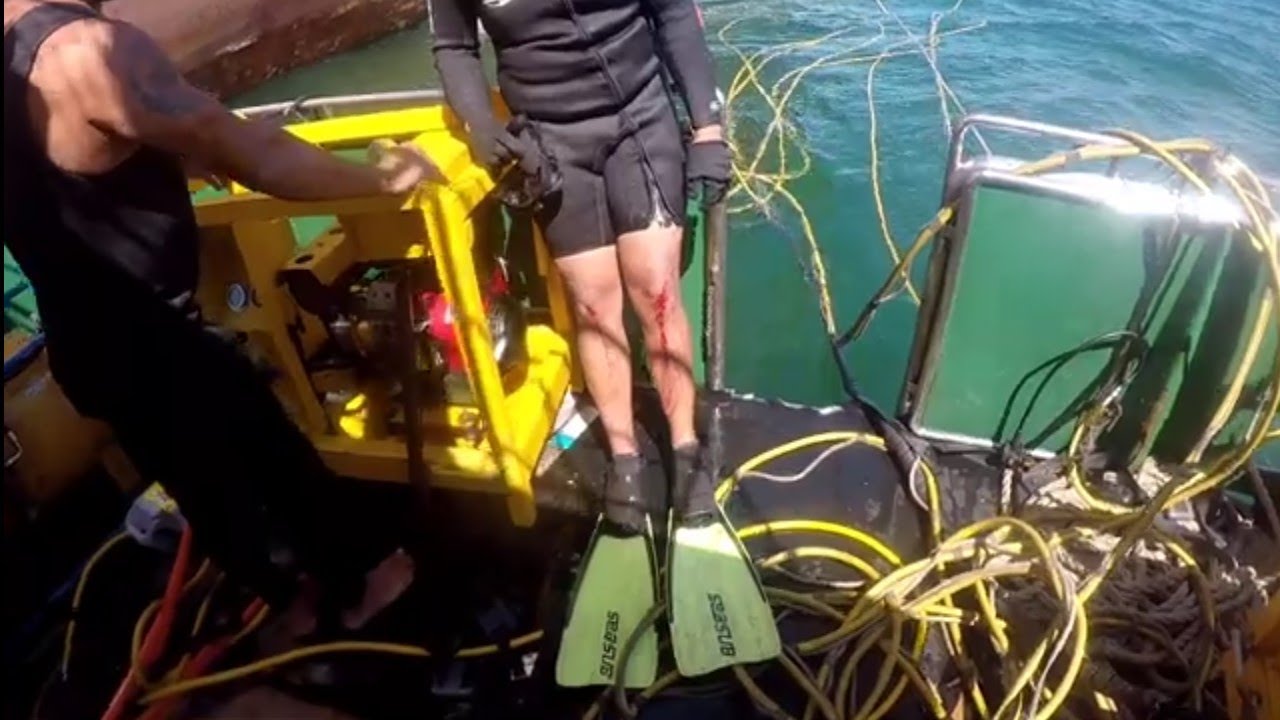 How the ship's hull is cleaning, in a dry dock and underwater by divers