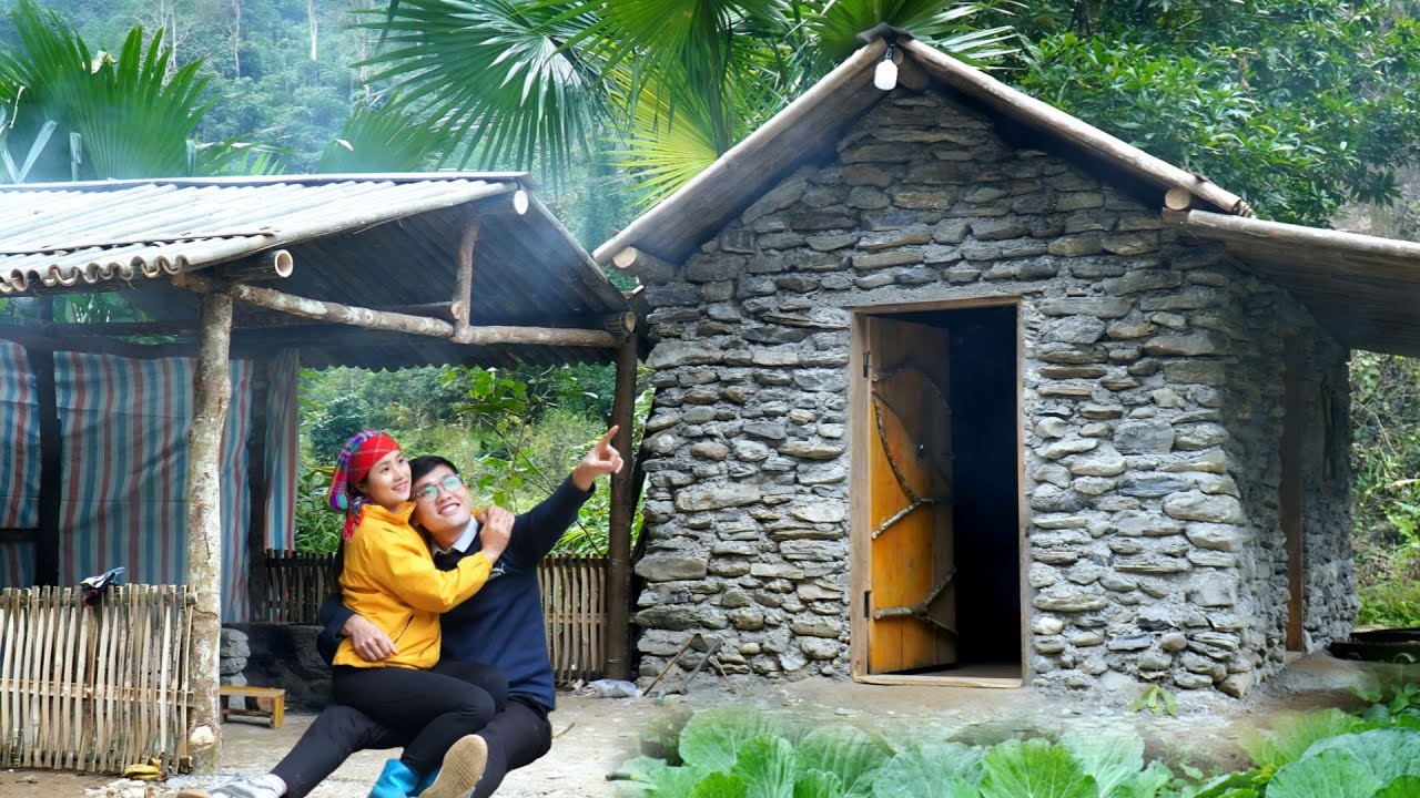 Quang & Linda — finishing our kitchen and sharing a warm meal in the home we built.