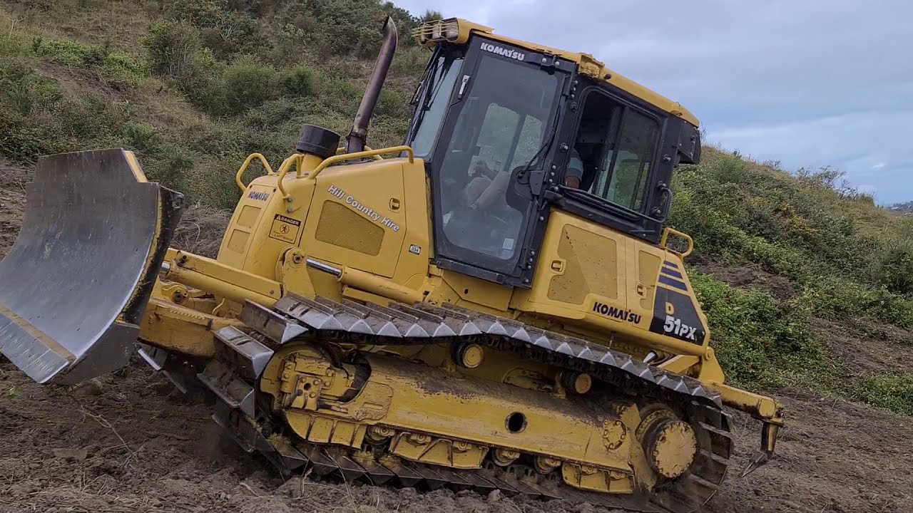 Kamatsu D5 Bulldozer clearing bush on steep hill country NZ