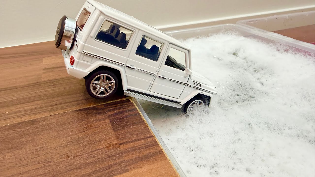 Various Toy Cars For Toddlers Falling Into The Foamy Water With Colors