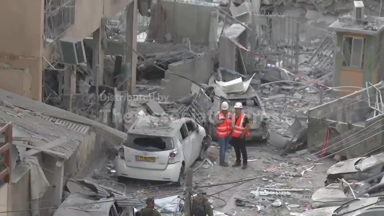 Buildings and vehicles damaged in aftermath of Iranian strike in Bnei Brak, Israel