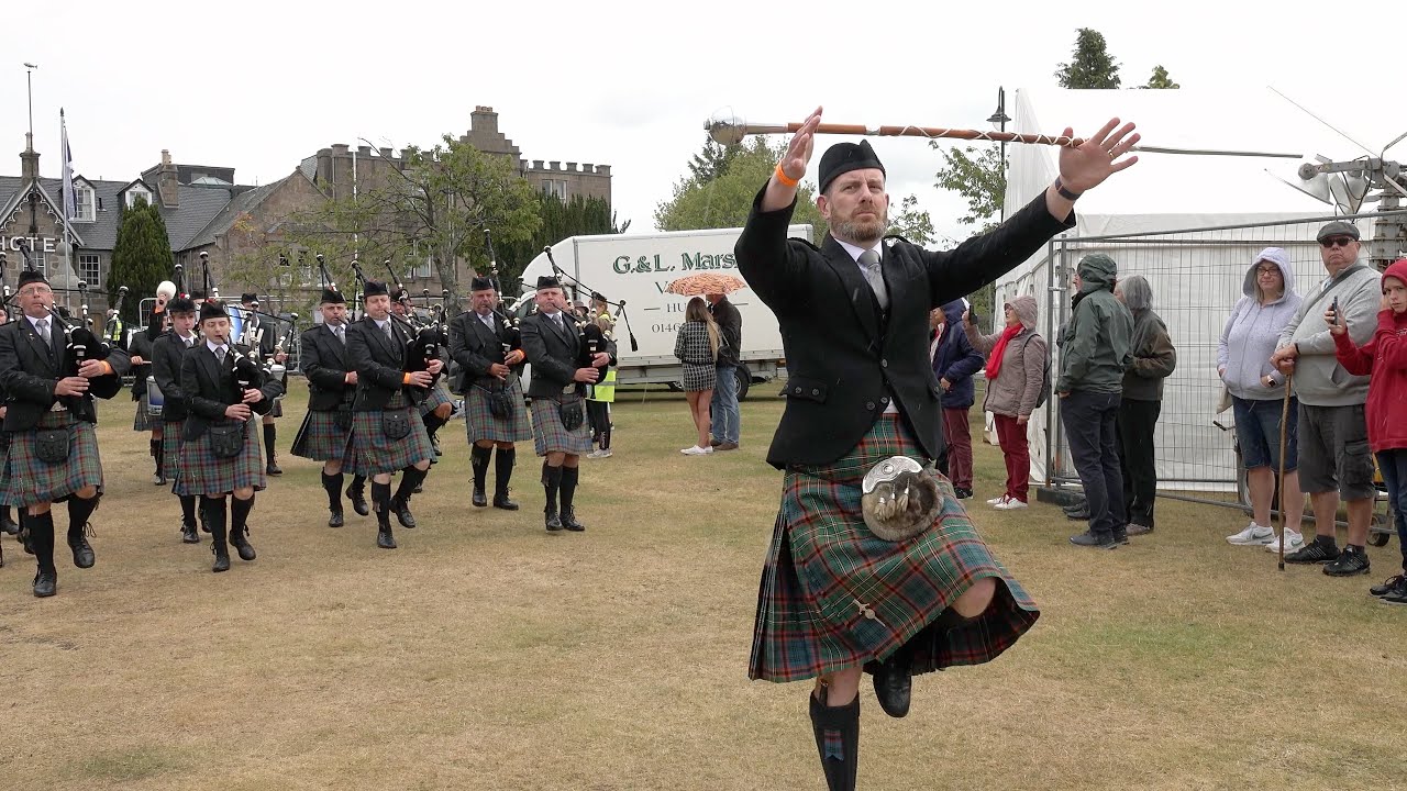 Ellon & District and Newtonhill Pipe Bands march into the 2022 Aboyne Highland Games in Scotland