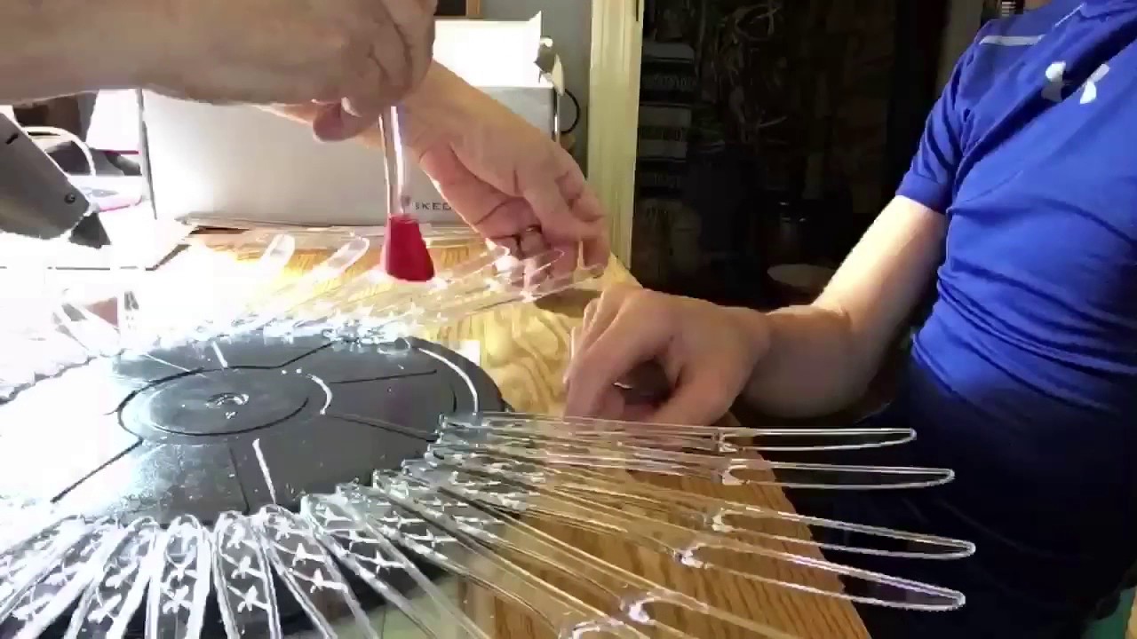 Recycled plastic knives project into a sunflower.