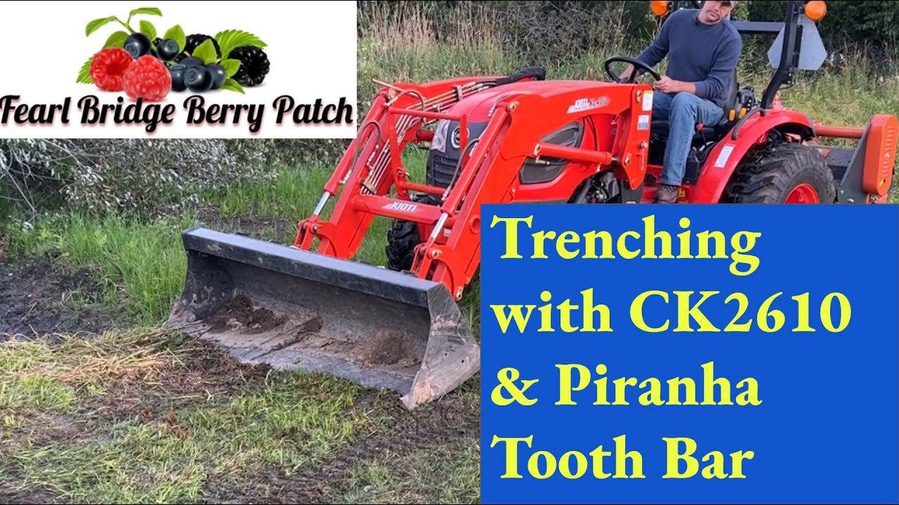 Kioti CK2610 and Piranha Tooth Bar Digging drainage ditch for corrugated pipe