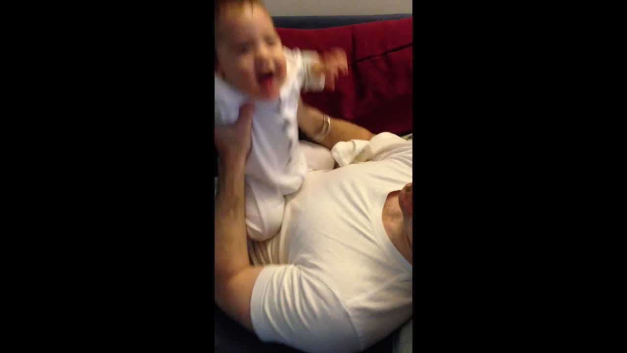 Baby laughs when daddy tickles his chin