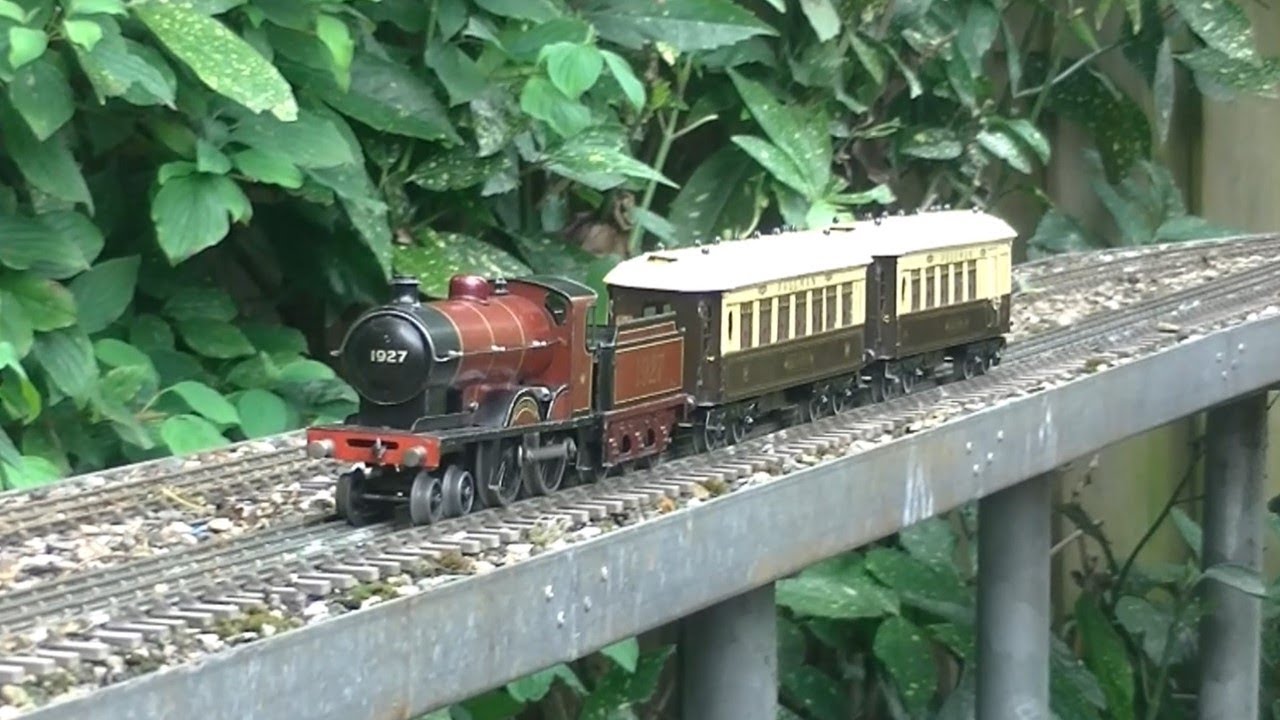 Bassett-Lowke and Hornby Tinplate Clockwork locomotives with a Hornby Pullman Train in the Garden
