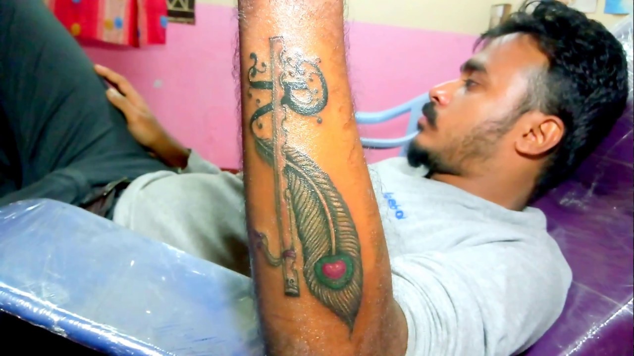 Peacock feather and flute tattoos finish