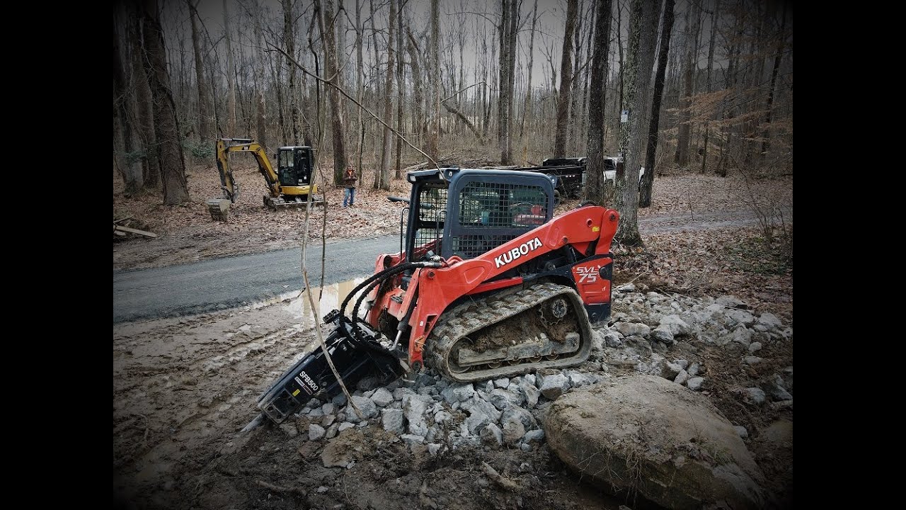 Busting Concrete with skid steer hydraulic breaker