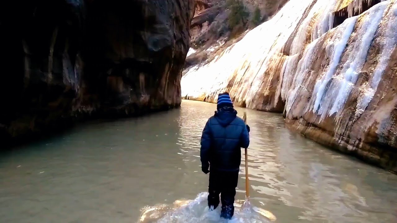 Hiking the Zion Narrows in icy cold freezing water during winter time
