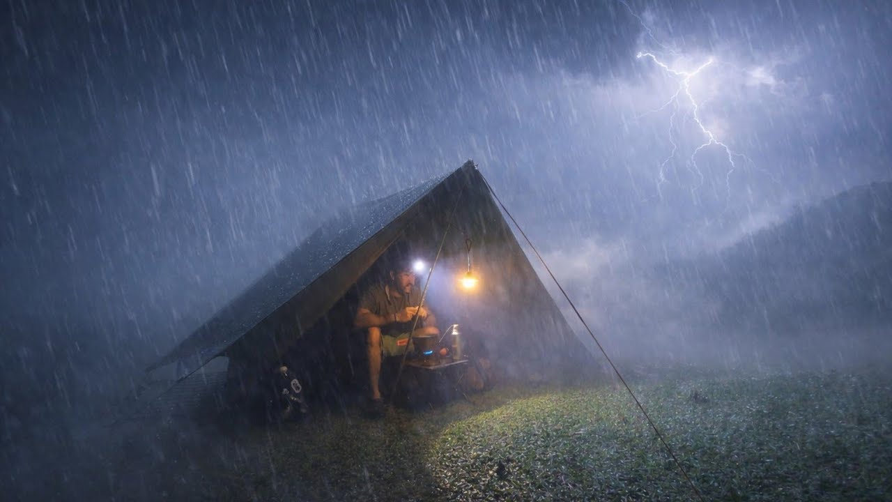 Solo camping very stormy night camping alone on top of a green hill