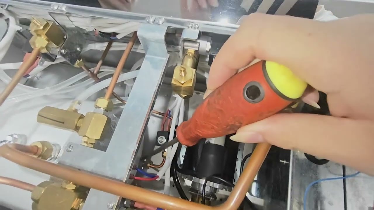 The hot water button of the coffee machine is still on and water is still dripping out.