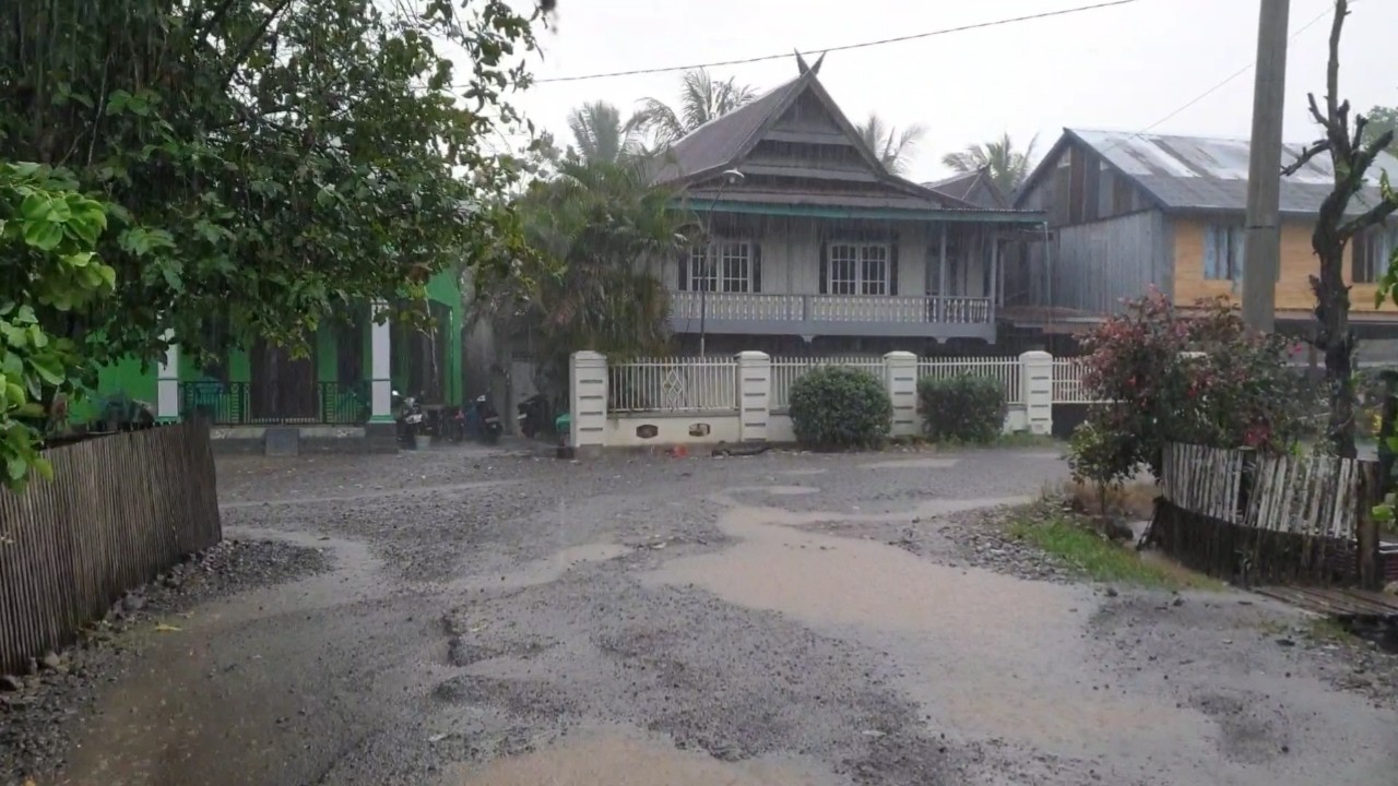 Walking amidst heavy rain and strong winds in rural Indonesia in South Sulawesi