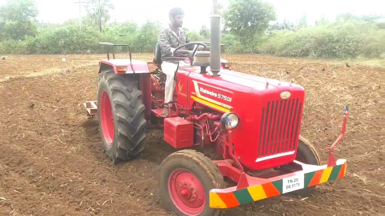 575 Mahindra tractor working in field with 9 tyne spring cultivator