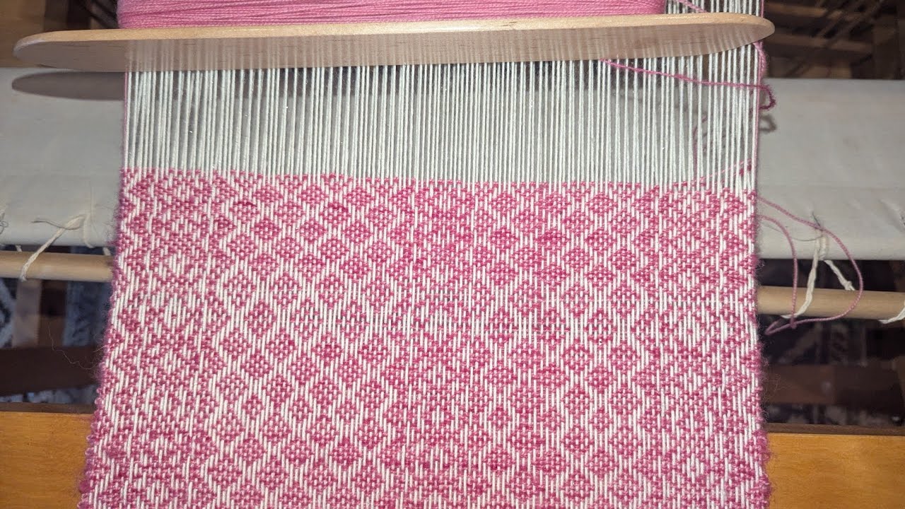Rolling a warp onto a Ridged Heddle Loom.