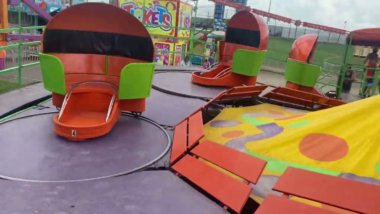 On board the orange and green  Tilt a whirl County Fair￼