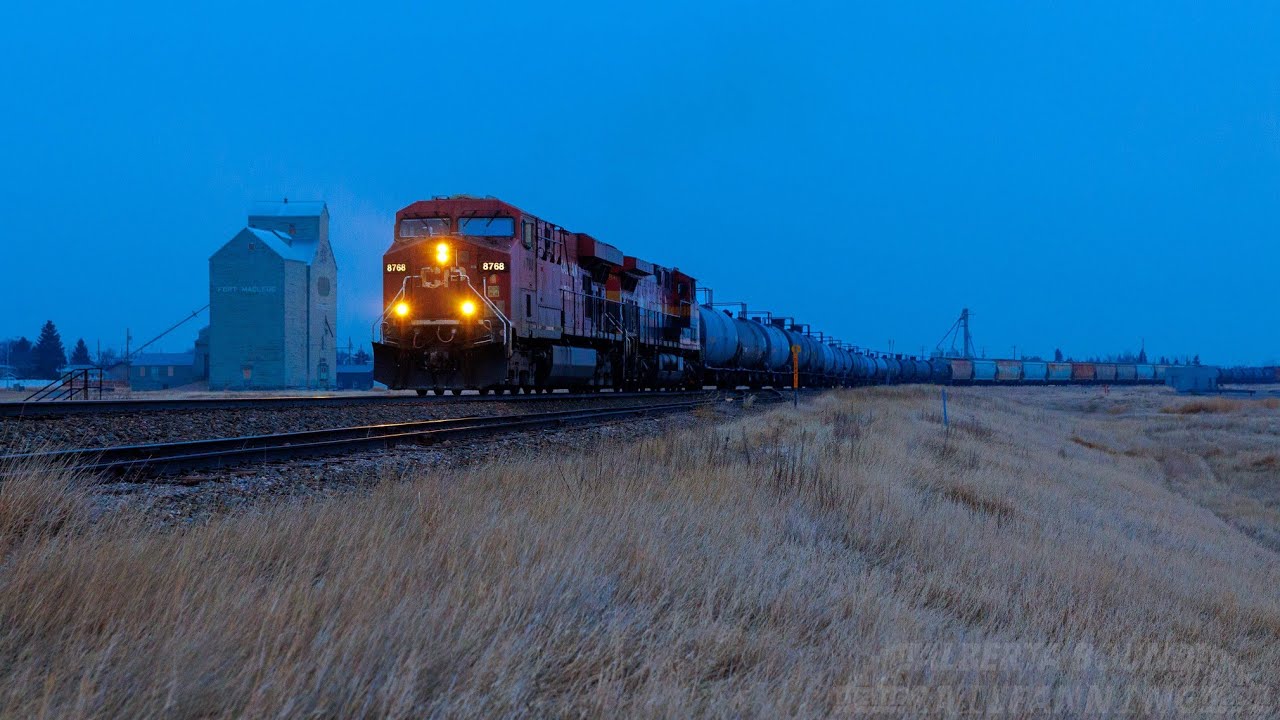 A CPKC Manifest Train Roars Through Fort Macleod, Alberta