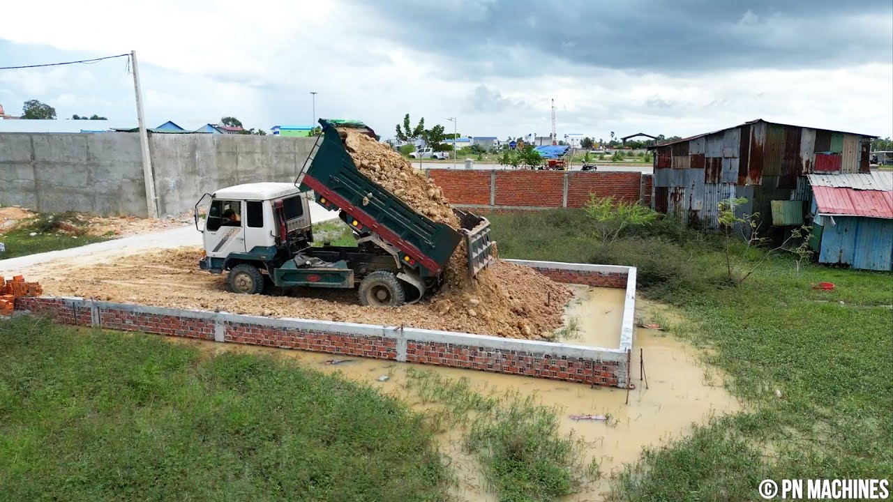 Starting Small Project Land filling Up With Mitsubishi Dozer And Dump Truck 5Ton Spreading Stone