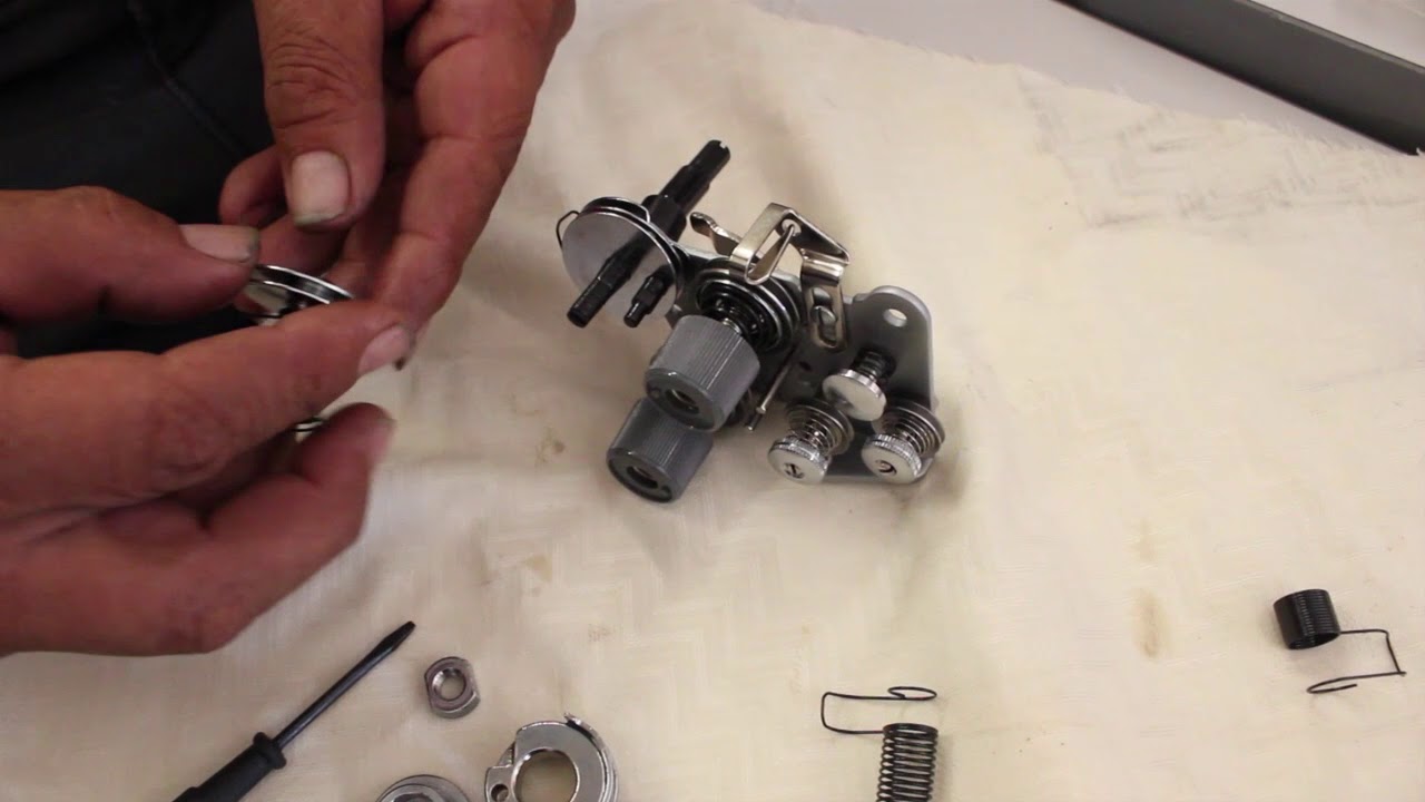 Installing springs on a double needle sewing machine