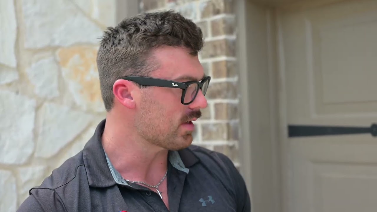 Jamie Walker showcases hail damage to a home in west Fort Worth during his roof replacement