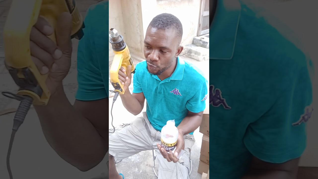 using a heat gun to shrink wrap a plastic bottle cap.