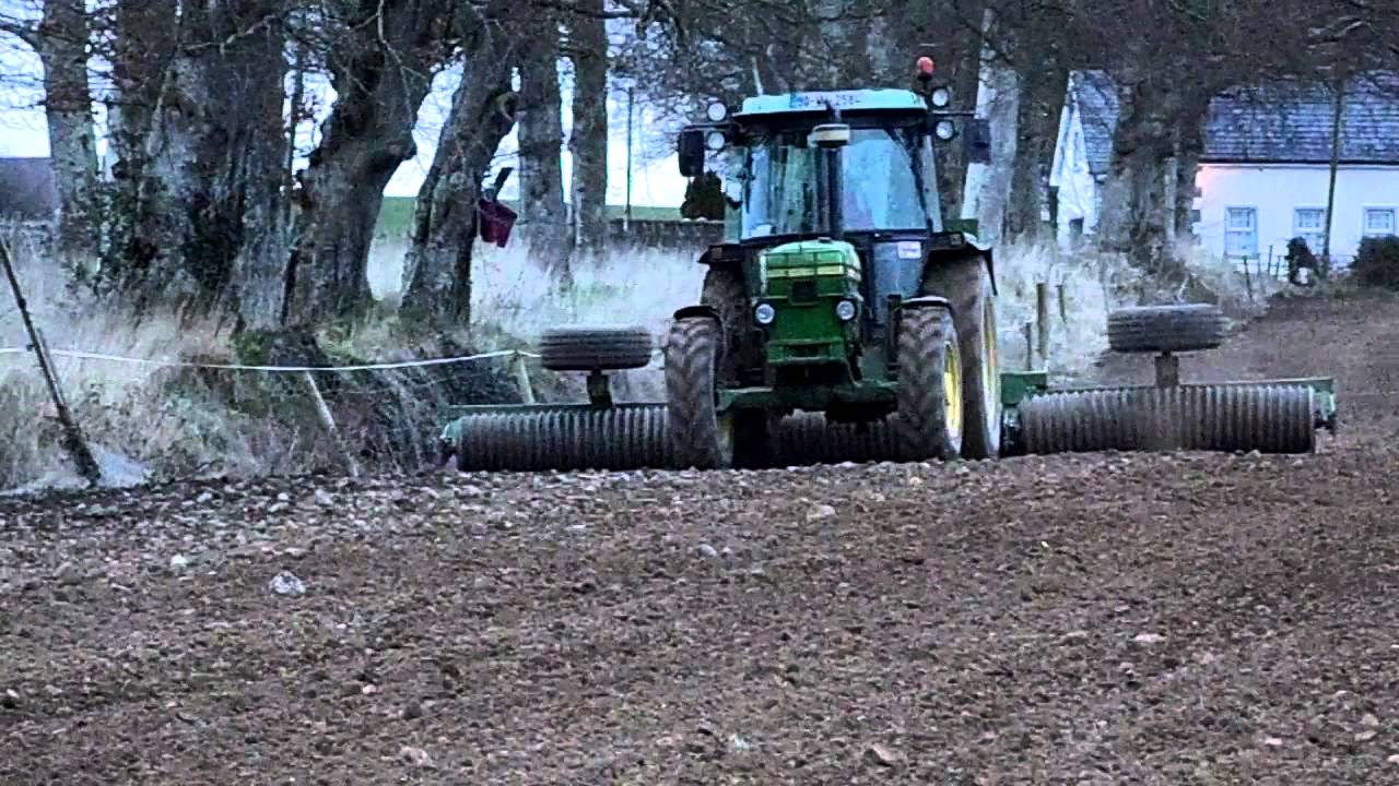 John Deere 2850 sowing and rolling spring barley 2015