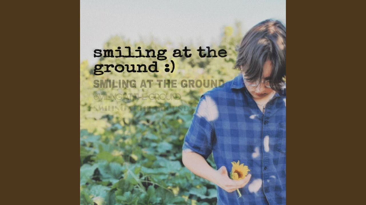 smiling at the ground