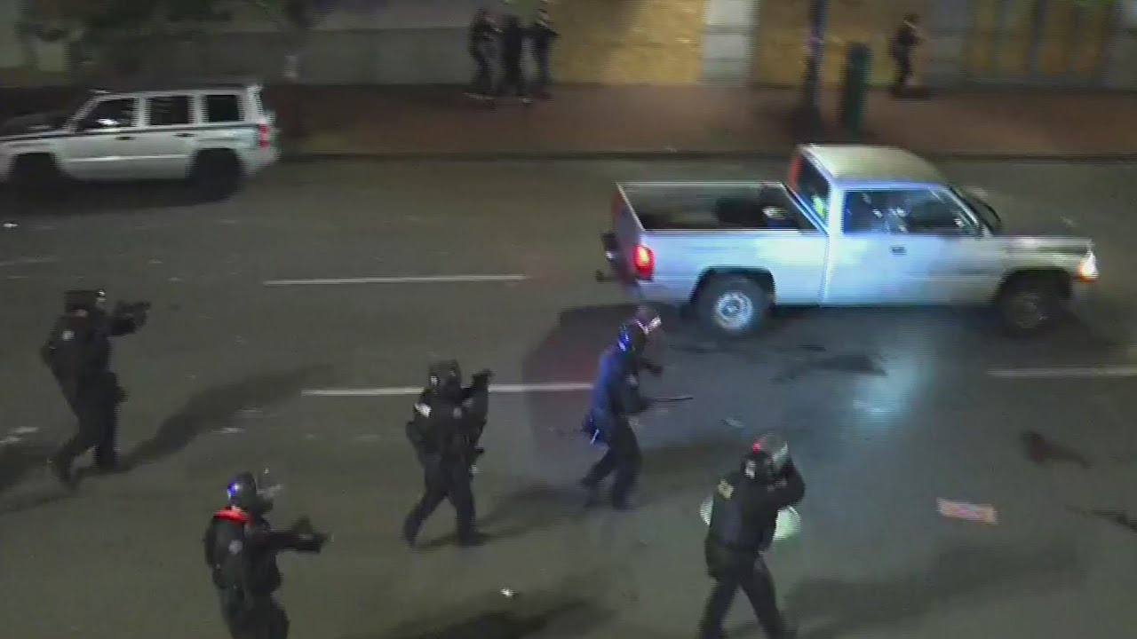 Police try to stop pickup truck driver amid protest chaos