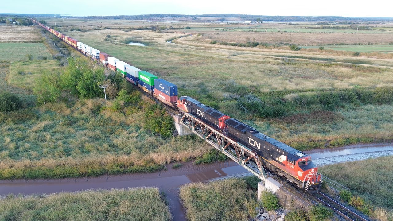 Awesome Aerial 4K View! Long Extra Stack Train CN X121 passing Nappan, NS at Track Speed